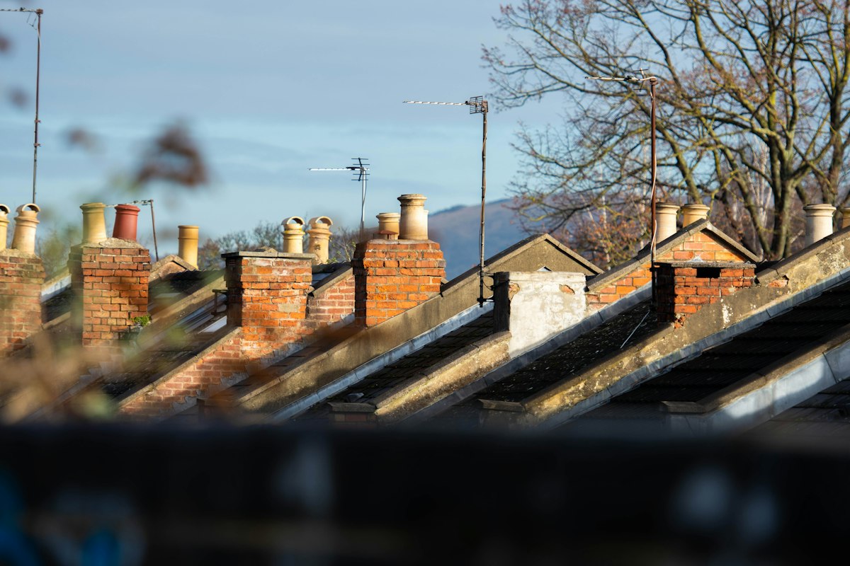 Brick chimney stacks on a UK roof