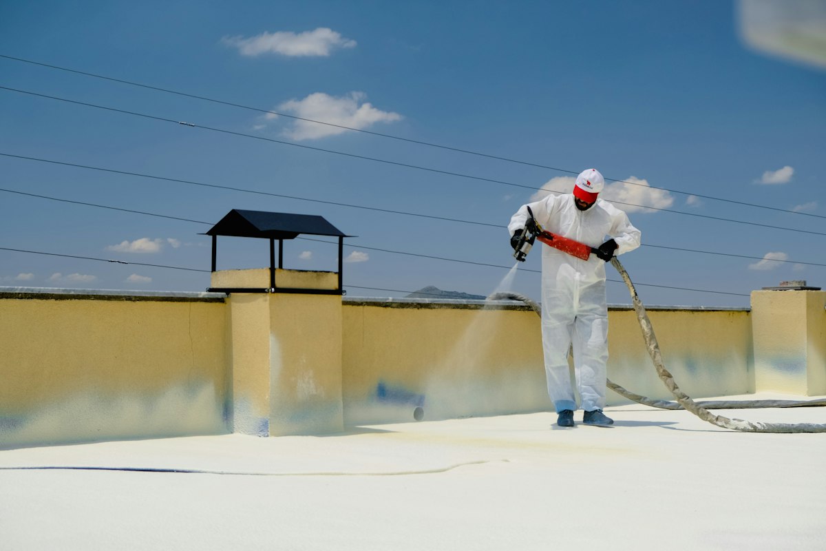 Roofer applying a liquid roof coating