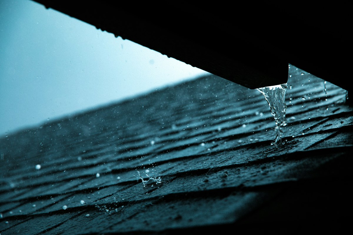 Close-up of a rain gutter on a tiled roof